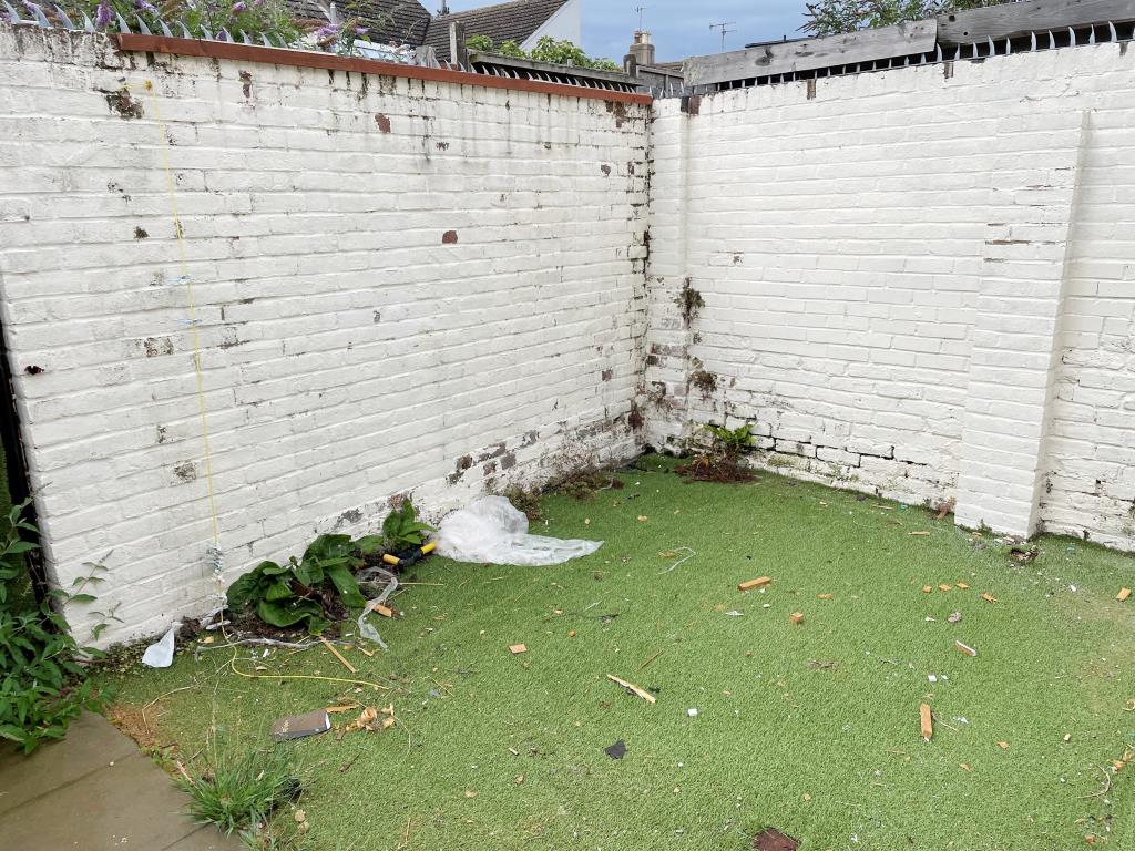 Lot: 19 - FREEHOLD HOUSE ARRANGED AS THREE FLATS IN CENTRAL WORTHING - View of walled south facing rear patio